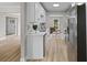 Modern white kitchen with stainless steel appliances and seamless flow into the living room area at 111 Driver Ave, Summerville, SC 29483