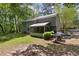 Back exterior featuring a screened in porch and outdoor patio area surrounded by a large yard at 111 Garden Hill Rd, Summerville, SC 29483