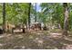 Backyard surrounded by a beautiful, densely wooded area with a trailer and a wooden table at 111 Garden Hill Rd, Summerville, SC 29483