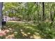 Spacious, grassy backyard and wooded area featuring a storage shed and plenty of space for outdoor activities at 111 Garden Hill Rd, Summerville, SC 29483