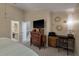 Bright bedroom featuring a desk, dresser with television, complemented by sunburst mirrors, creating a stylish and comfortable space at 111 Garden Hill Rd, Summerville, SC 29483