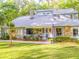 Charming two-story home with stone accents, well-manicured lawn, and American flag at 111 Garden Hill Rd, Summerville, SC 29483