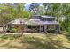 Well maintained home showcasing a stone facade, lush landscaping and a welcoming front porch at 111 Garden Hill Rd, Summerville, SC 29483