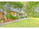 Landscaped front yard leading to a cozy home with stone and siding details and a lovely garden at 111 Garden Hill Rd, Summerville, SC 29483