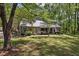 Inviting home exterior featuring mature landscaping, a stone facade and a welcoming front porch at 111 Garden Hill Rd, Summerville, SC 29483