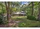 Two-story home featuring gray stone and siding, situated in a yard surrounded by lush green trees at 111 Garden Hill Rd, Summerville, SC 29483