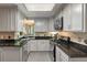 Well-lit kitchen features granite countertops, stainless steel appliances, and tiled backsplash at 111 Garden Hill Rd, Summerville, SC 29483