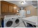 Functional laundry room with ample cabinet space, washer, dryer, and folding table at 111 Garden Hill Rd, Summerville, SC 29483