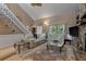 Bright living room featuring a staircase, comfortable seating, and a large decorative rug at 111 Garden Hill Rd, Summerville, SC 29483
