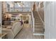 Open-concept living area featuring a stone fireplace, hardwood floors, and staircase at 111 Garden Hill Rd, Summerville, SC 29483