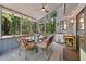 Cozy sunroom with tiled floor and screened in windows, surrounded by green trees, with a chandelier and dining set at 111 Garden Hill Rd, Summerville, SC 29483