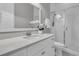 Bright bathroom features a vanity with quartz countertop, framed mirror, and glass shower at 112 Brailsford St, Charleston, SC 29492