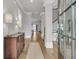 Bright foyer with hardwood floors, an antique cabinet, and views into the living spaces at 112 Brailsford St, Charleston, SC 29492