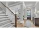Inviting foyer with a wooden staircase, hardwood floors, and an elegant entry at 112 Brailsford St, Charleston, SC 29492