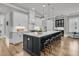Bright kitchen features a large island with seating, white cabinets, and stainless steel appliances at 112 Brailsford St, Charleston, SC 29492