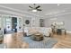 Bright living room with hardwood floors, modern furnishings, and access to the porch at 112 Brailsford St, Charleston, SC 29492