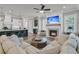 Open-concept living room with a fireplace, a large sofa, and a kitchen island at 112 Brailsford St, Charleston, SC 29492