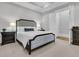 Luxurious main bedroom featuring a tufted headboard, bedside tables, and elegant decor at 112 Brailsford St, Charleston, SC 29492