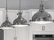 Close-up of modern pendant lighting over a kitchen island, complementing the cabinetry at 112 Brailsford St, Charleston, SC 29492