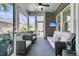 Relaxing sunroom with comfortable seating, ceiling fan, and views of the backyard at 112 Brailsford St, Charleston, SC 29492