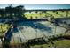 Aerial view of community tennis courts surrounded by trees and landscaping on a bright sunny day at 112 Brailsford St, Charleston, SC 29492