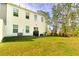 Well-maintained backyard with lush green grass, patio, and a view of tall trees at 115 E East Sunrise Lane, Summerville, SC 29486