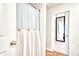 Bathroom featuring a toilet and unique shower curtain with wood button accents and a door with mirror at 115 E East Sunrise Lane, Summerville, SC 29486