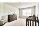 Neutral Bedroom featuring a wooden crib, dresser, and window offering natural light in a cozy space at 115 E East Sunrise Lane, Summerville, SC 29486