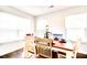 Bright dining room with wood floors, a wooden table, and lots of natural light from the large windows at 115 E East Sunrise Lane, Summerville, SC 29486