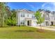 Charming two-story home with attached garage, well-manicured lawn, and inviting curb appeal at 115 E East Sunrise Lane, Summerville, SC 29486