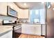 Bright kitchen features stainless appliances, sleek gray countertops, and ample cabinet space at 115 E East Sunrise Lane, Summerville, SC 29486