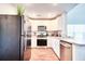Updated kitchen features stainless steel appliances, modern white cabinets, and wood look flooring at 115 E East Sunrise Lane, Summerville, SC 29486