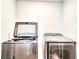 Laundry room equipped with a front-load washer and dryer set for efficient cleaning at 115 E East Sunrise Lane, Summerville, SC 29486