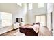 Open living area features vaulted ceilings, lots of natural light, wood floors, and a plush sofa at 115 E East Sunrise Lane, Summerville, SC 29486