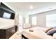 Bright main bedroom boasts a dresser with TV, a walk-in closet, and multiple windows at 115 E East Sunrise Lane, Summerville, SC 29486