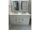 Modern bathroom with double vanity, white cabinetry, and white framed mirrors at 1300 Park West Blvd # 516, Mount Pleasant, SC 29466