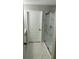 Bathroom with white marble tile, glass enclosed shower, and door at 1300 Park West Blvd # 516, Mount Pleasant, SC 29466