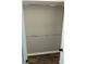 Open closet with two chrome bars for hanging clothes and dark wood-look laminate flooring at 1300 Park West Blvd # 516, Mount Pleasant, SC 29466