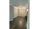 Dining area leading to open kitchen, with a modern hanging light fixture and hardwood flooring at 1300 Park West Blvd # 516, Mount Pleasant, SC 29466