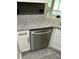 Stainless steel dishwasher with granite countertops and black tile backsplash in the kitchen at 1300 Park West Blvd # 516, Mount Pleasant, SC 29466