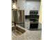 Kitchen with stainless steel appliances, granite countertops, white cabinets, and black tile backsplash at 1300 Park West Blvd # 516, Mount Pleasant, SC 29466