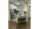 Kitchen island with barstool seating, stainless steel appliances, white cabinets, and granite countertops at 1300 Park West Blvd # 516, Mount Pleasant, SC 29466