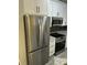 Stainless steel refrigerator and appliances with white cabinets and granite countertops in the kitchen at 1300 Park West Blvd # 516, Mount Pleasant, SC 29466