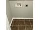 Laundry room detail of plumbing fixture, electrical outlet and tile flooring at 1300 Park West Blvd # 516, Mount Pleasant, SC 29466