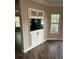 Living room with built-in cabinets and shelving with natural light from the window at 1300 Park West Blvd # 516, Mount Pleasant, SC 29466