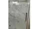 Close-up of shower with white marble tile, glass door, and chrome fixtures at 1300 Park West Blvd # 516, Mount Pleasant, SC 29466