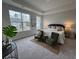 Bright bedroom featuring two chairs, neutral decor, and multiple windows for natural light at 131 Brown Swiss Cir, Summerville, SC 29483