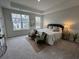 Bedroom with neutral tones and a large window showing neighborhood view at 131 Brown Swiss Cir, Summerville, SC 29483