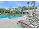 Resort-style community pool with lounge chairs, a hot tub, and palm trees for relaxation and recreation at 131 Brown Swiss Cir, Summerville, SC 29483