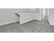 Bright hallway with gray carpet, white trim, and a staircase leading to the upper level at 131 Brown Swiss Cir, Summerville, SC 29483